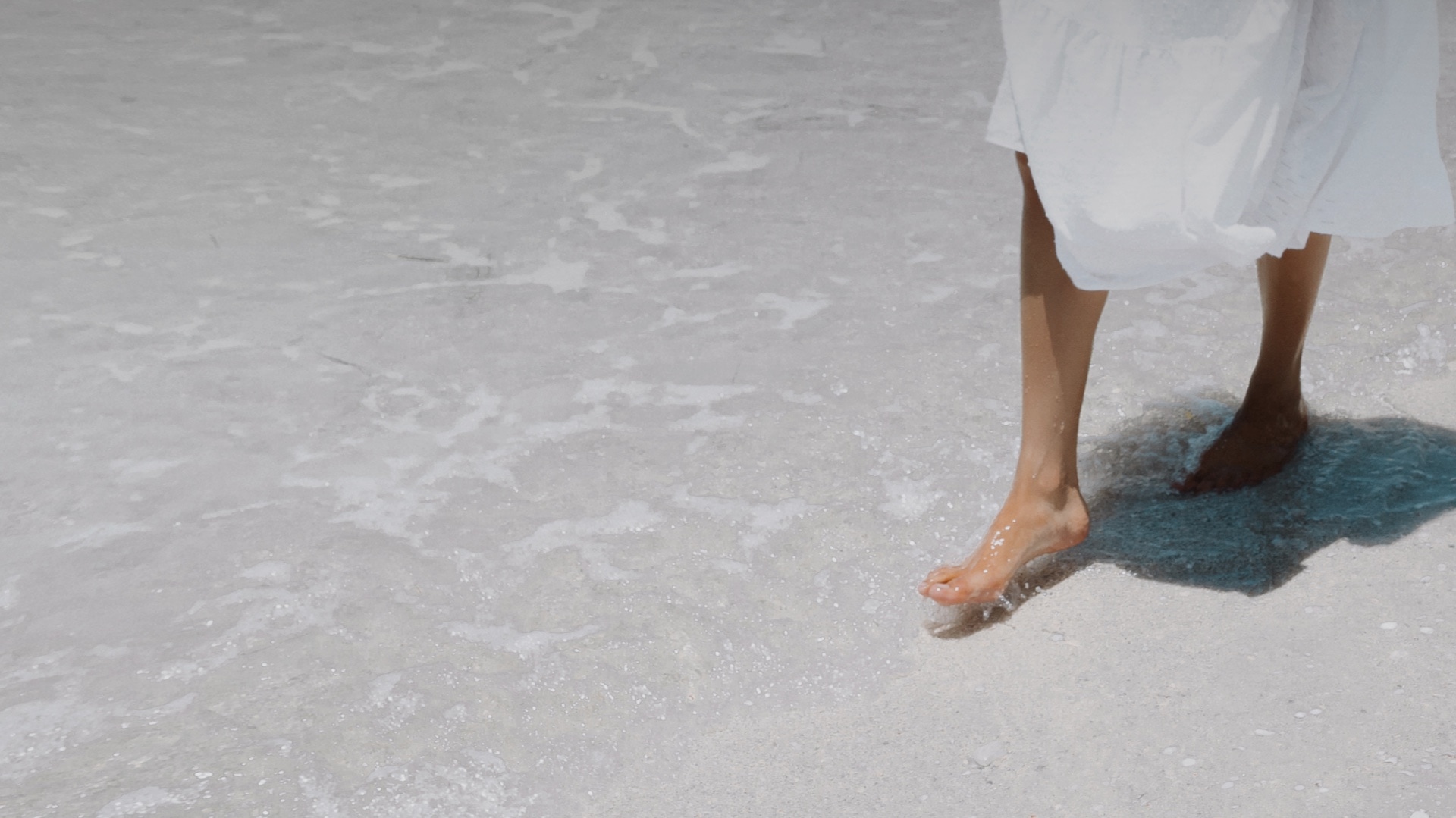 Woman walking on the beach Serena by the Sea